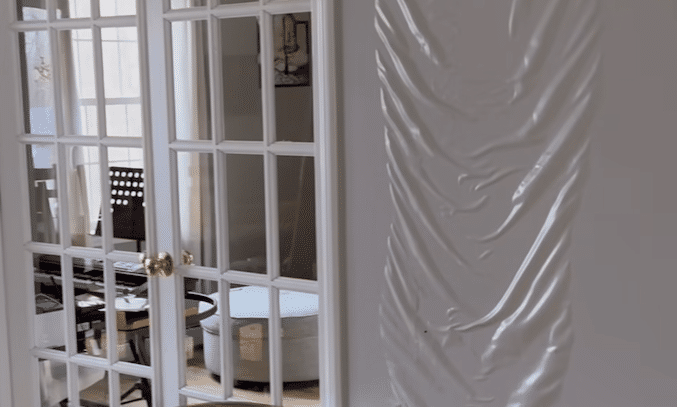 Severe water damage causing wall bulging and ceiling leak inside a home in Waxhaw NC