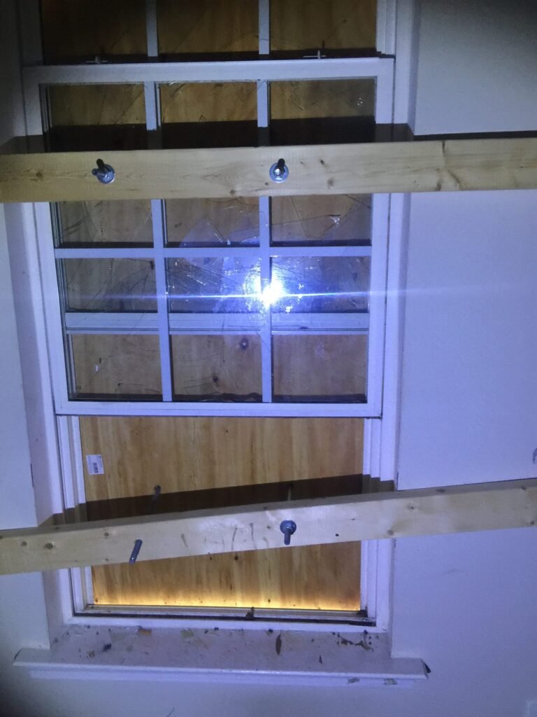 emergency board up on broken window after storm damage in Charlotte NC