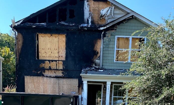 Technicians installing emergency board up after fire damage in Charlotte NC