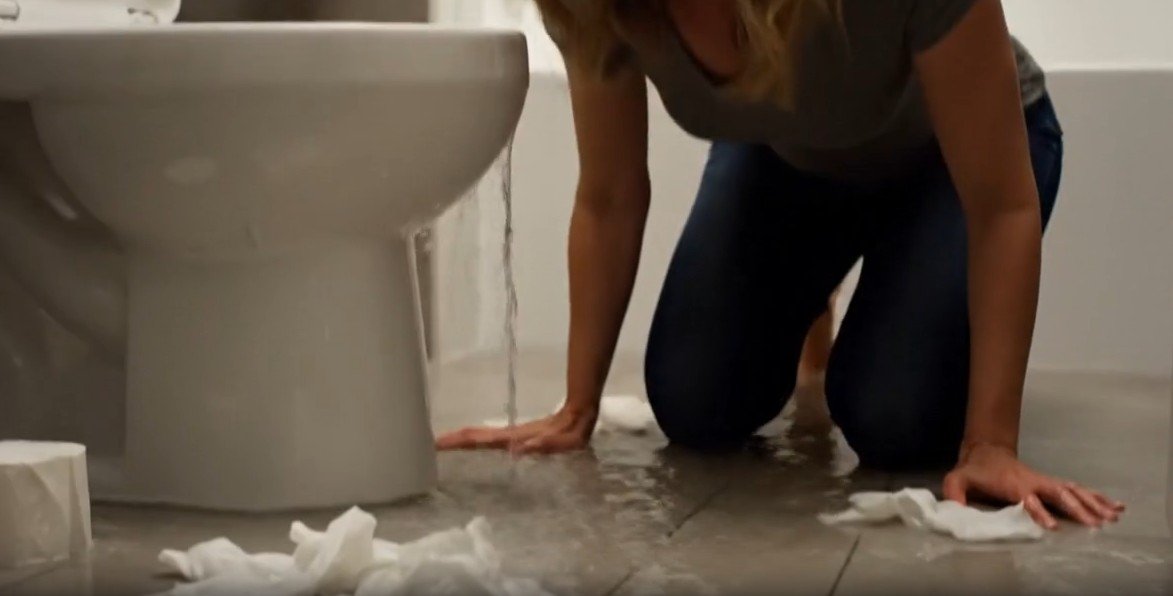 Toilet overflow causing sewage water on bathroom floor requiring sewage cleanup in Charlotte NC