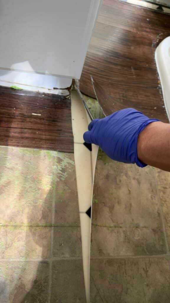 Old vinyl flooring layers with potential asbestos during demolition