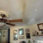 Stained ceiling with water damage visible.