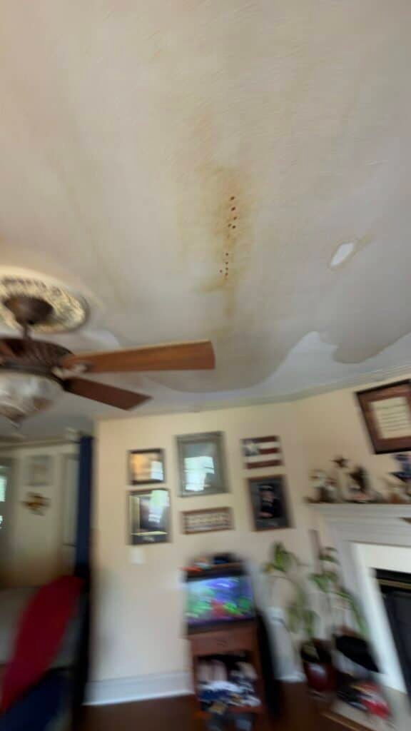 Water damage ceiling with sagging drywall and visible moisture stains