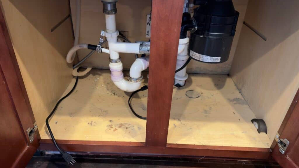 Mold remediation cost in Charlotte NC area: microbial growth on a sink base cabinet floor in Gastonia